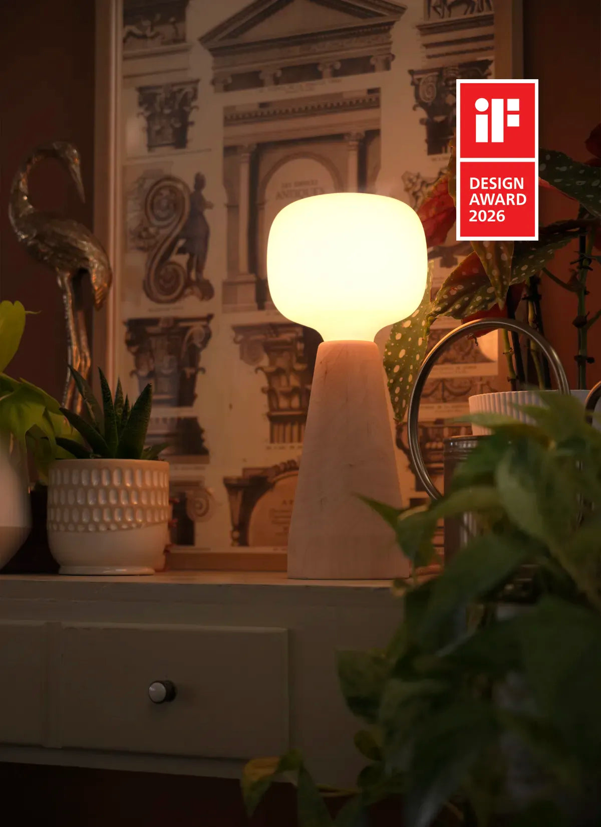 Soltech Aura surrounded by potted plants on a green background