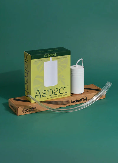 Soltech grow light set which includes a White Gen 2 Aspect, transparent wall mount Archetto on a wooden board against a green background. Bethlehem Star Bundle.