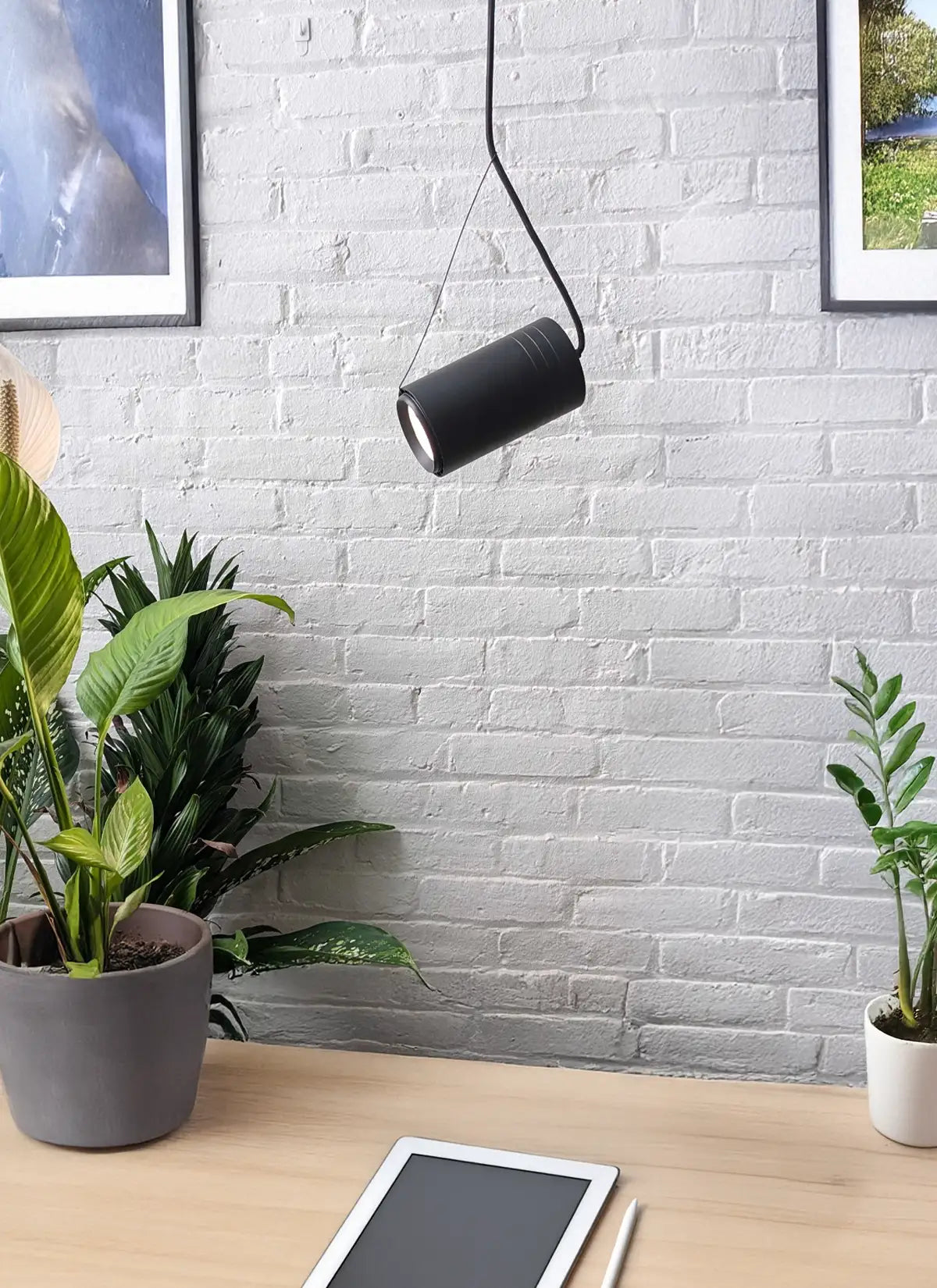 Modern office setup with a Soltech Aspect Angle kit and a black Soltech Aspect Gen 2 angled at plants with a tablet on a surface below, against a white brick wall.