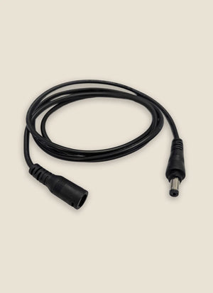 Black electrical cable with connectors on a beige background