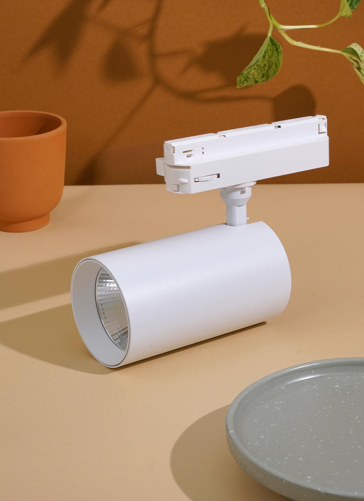 A white Soltech Highland positioned on a surface with a small pot in the background