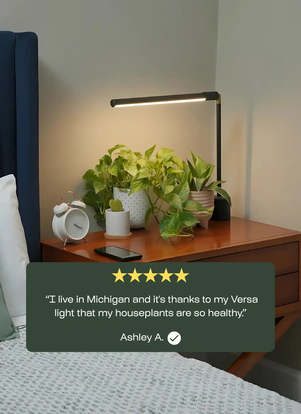 Bedroom scene with a bedside table, Soltech Versa, and houseplants, featuring a five-star review from Ashley A.