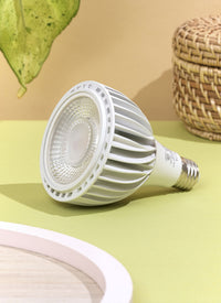 A white Soltech Vita displayed against a yellow background with a wicker object and a green leaf in the backdrop.