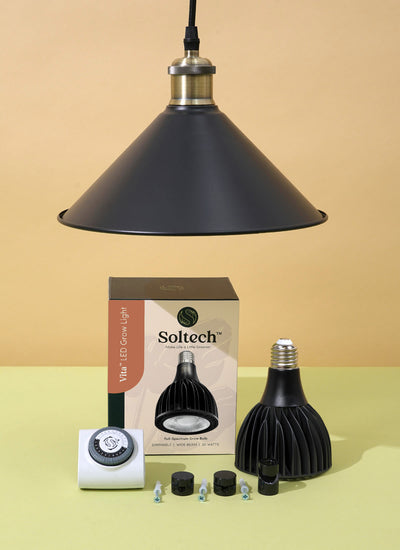 Black Soltech Vita grow light kit including a pendant light fixture, Metal lampshade, bulb, fabric cord, wall fairleads, hook, and outlet timer. 