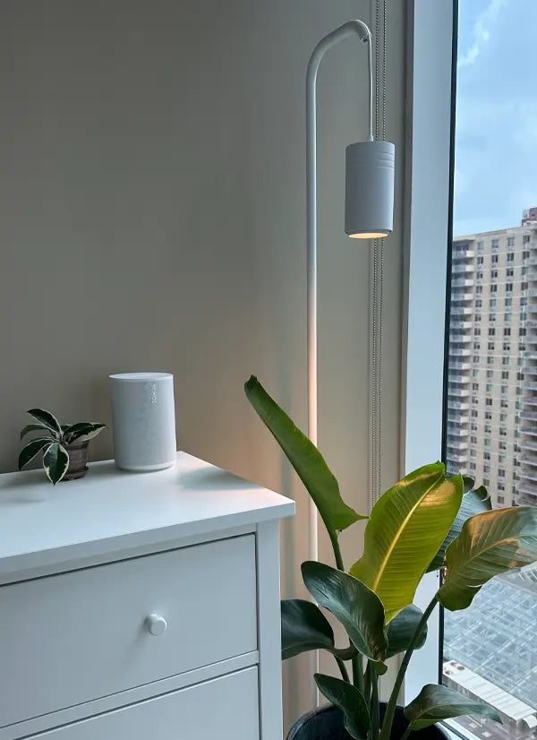 White dresser with a Soltech Stello and Soltech Aspect and plant next to a window with cityscape view
