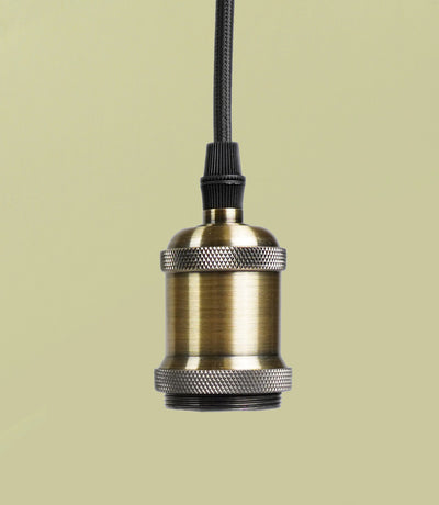 A bronze pendant with a metallic socket and a fabric cord against a light background.