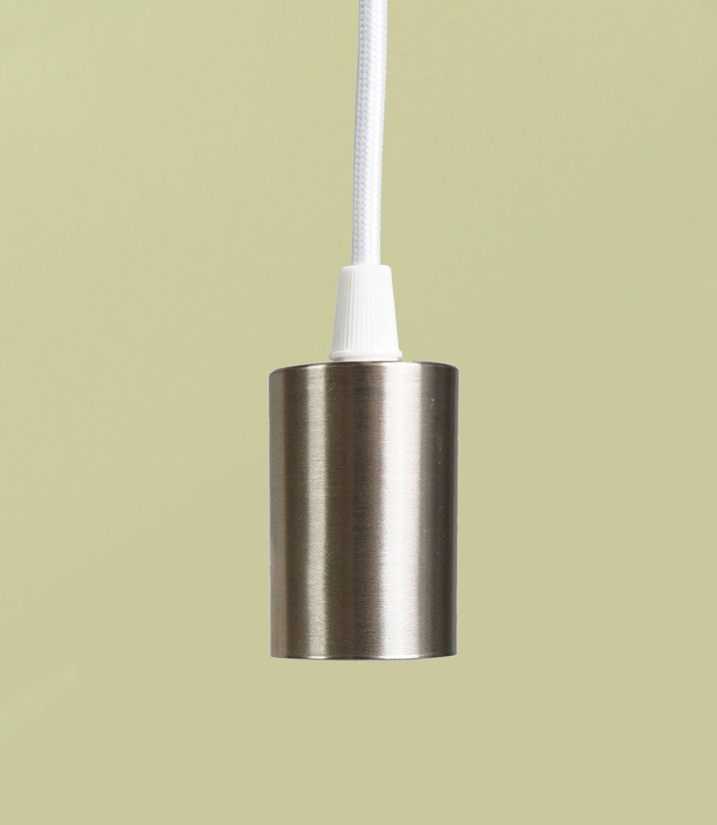 A bronze pendant with a metallic socket and a fabric cord against a light background.